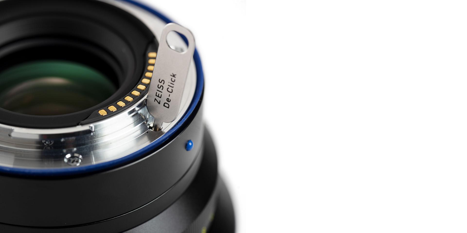 Close-up view of a ZEISS camera lens mount showing electronic contacts and detailed metal construction.