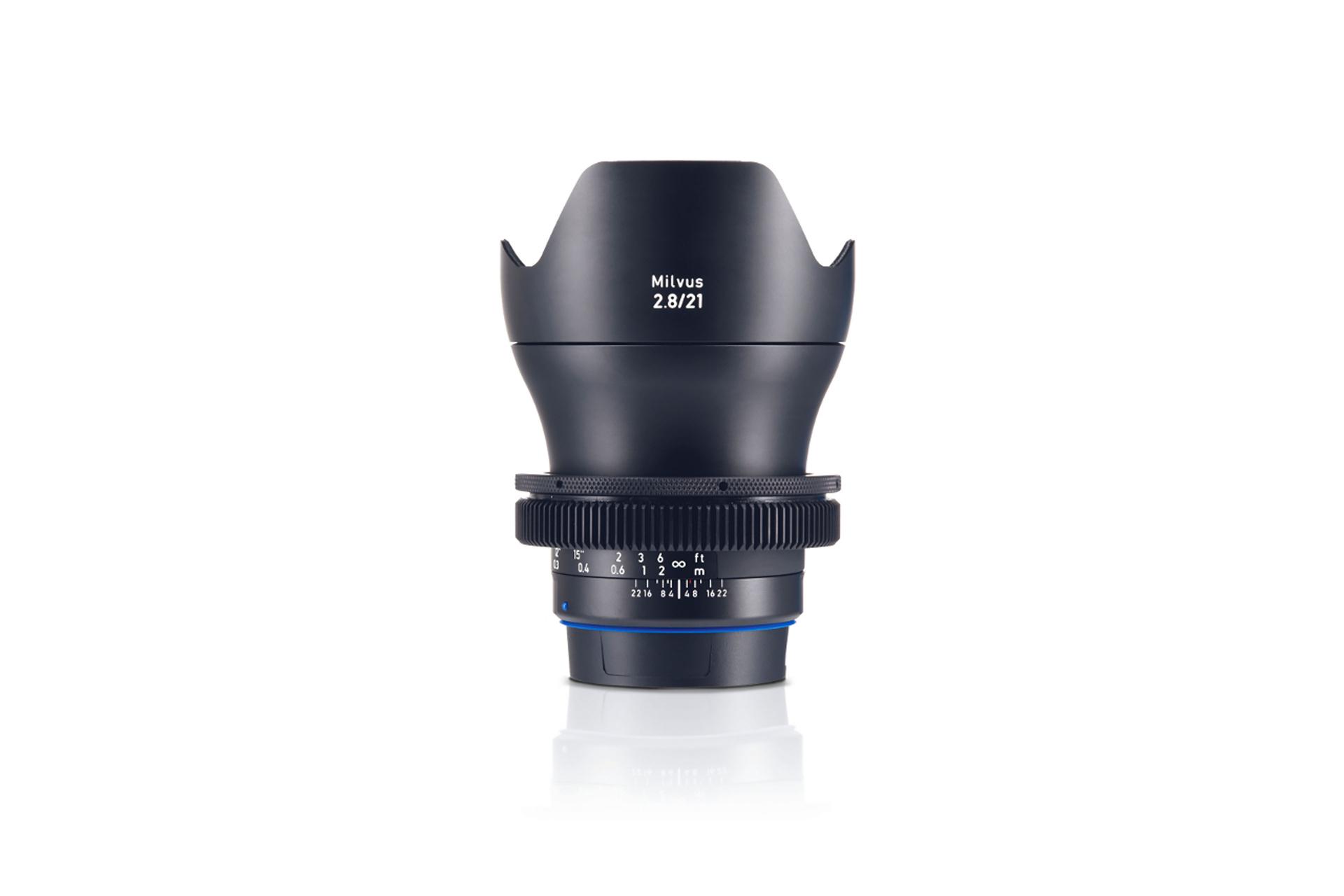Front view of a ZEISS Milvus 2.8/21 camera lens with focus and aperture rings visible.