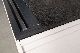 Here you can see the granite in a used measuring device being visually inspected for defects.